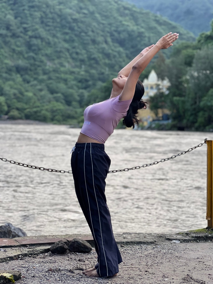 Vandana in a standing backbend by the Ganga in Rishikesh